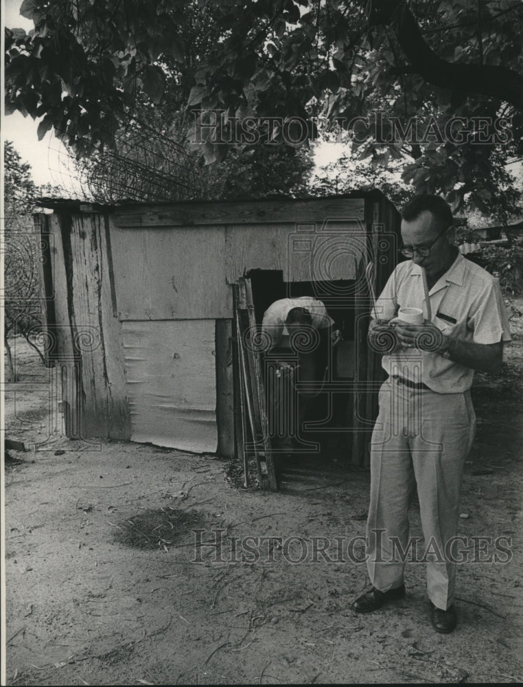 1964 Press Photo Man sprays for mosquitoes in a Houston shed - hca46683