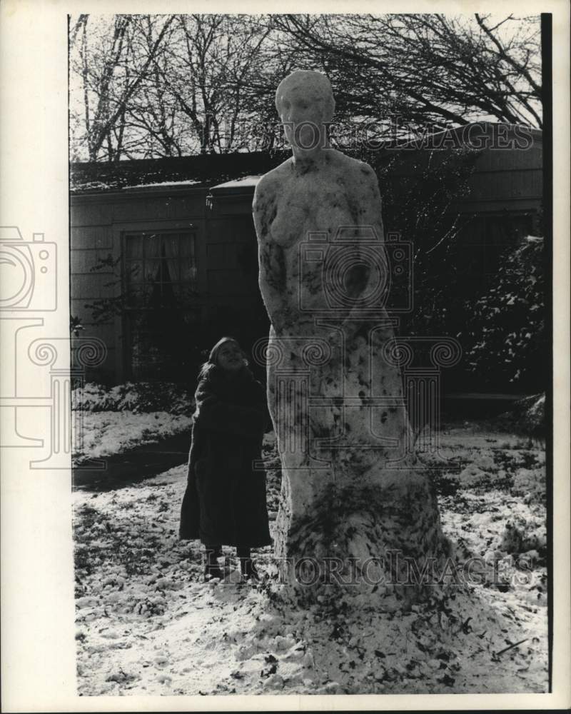 1969 Press Photo A girl in Houston stands next to a large snow sculpture