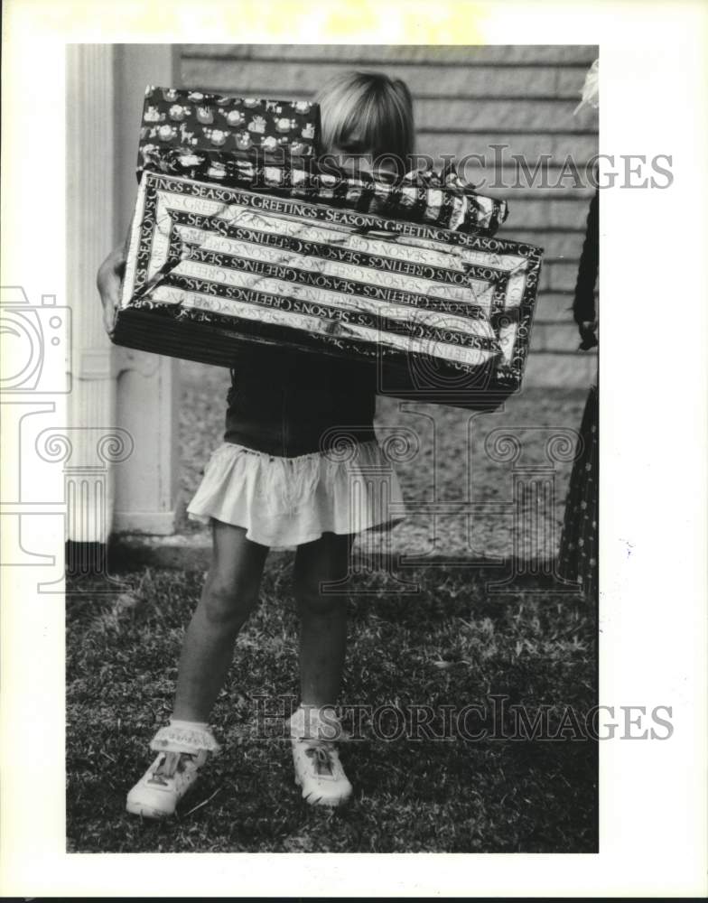 1988 Press Photo Jessica Miller Carries Gifts for Marines Toys for Tots, Houston- Historic Images