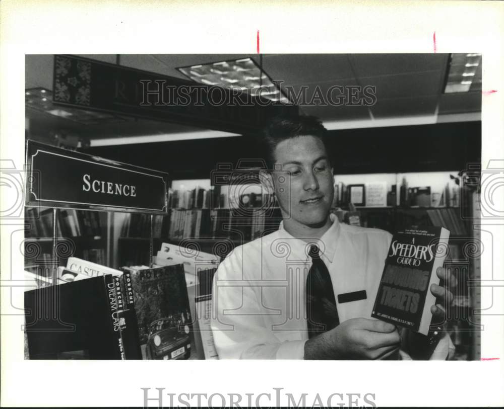 1991 Press Photo Brian Hunter, book salesman, holds guide book, Houston, Texas- Historic Images