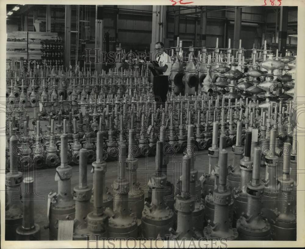 1969 Press Photo A.C. Hobbs, supervisor ACF Industries checks valves, Houston TX- Historic Images