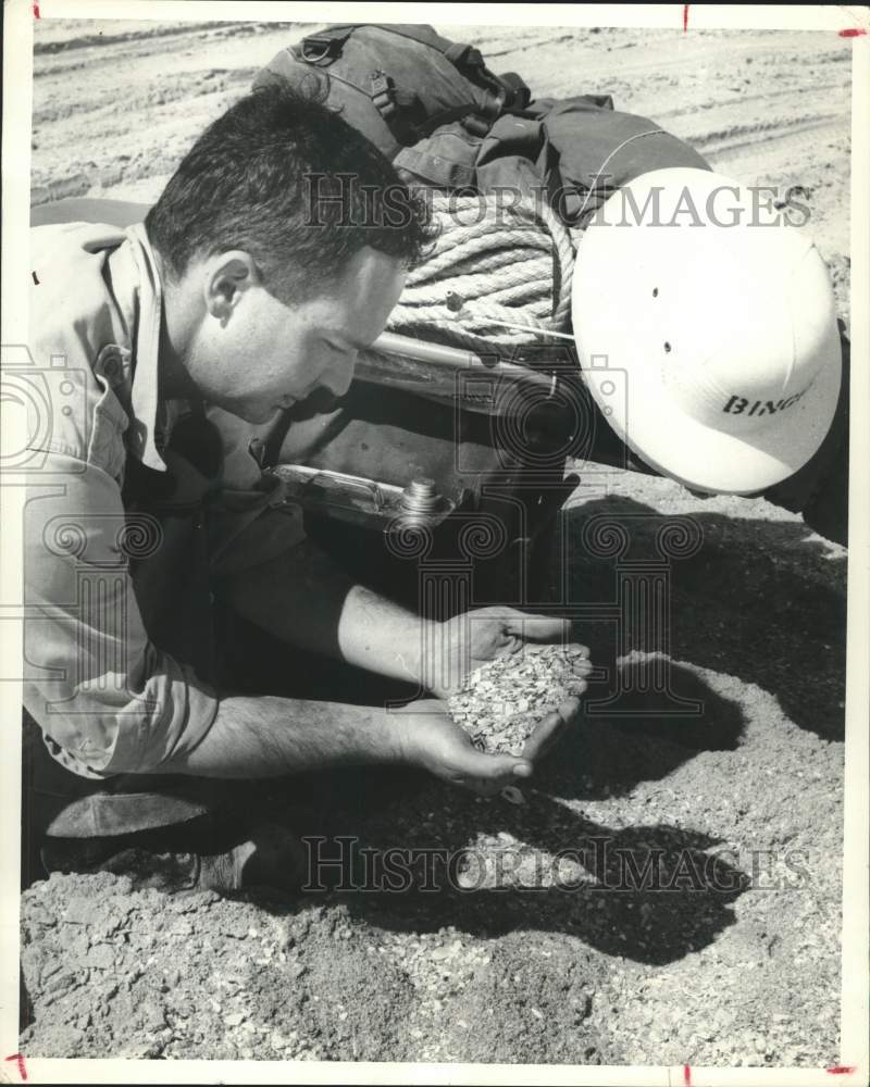 1962 Press Photo Workers examine piles of broken clam shells on Padre Island, TX- Historic Images