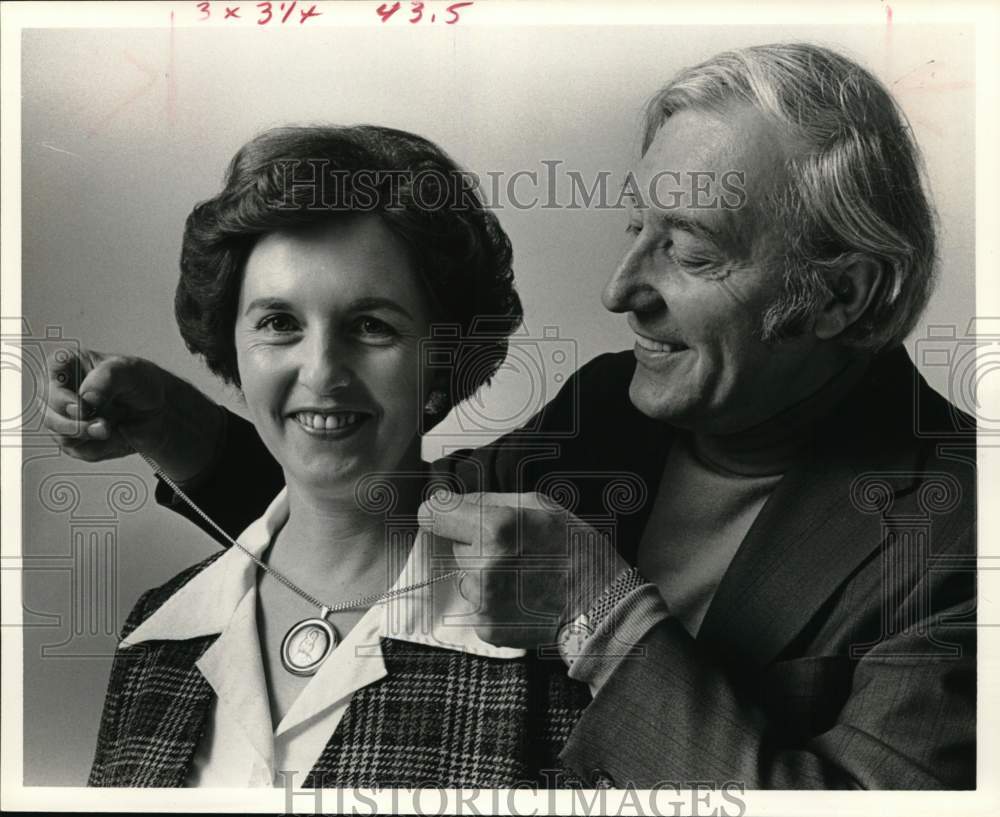 1976 Press Photo Vassil Ekimov puts medallion necklace on model - hca90597