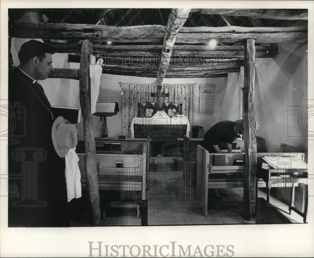 1964 Press Photo Reverend Jack Langford looking around inside a church.- Historic Images