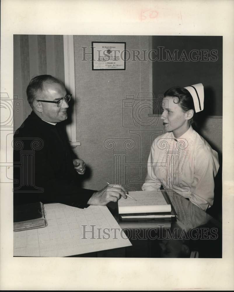 1958 Press Photo Newman Club Chaplain Reverend Gerard Joubert speaks to nurse- Historic Images