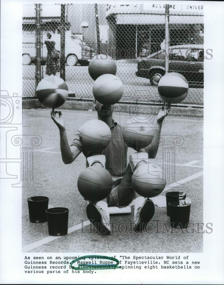 1988 Press Photo Maxwell Ruppe spins eight basketballs on his body - hcb27093- Historic Images