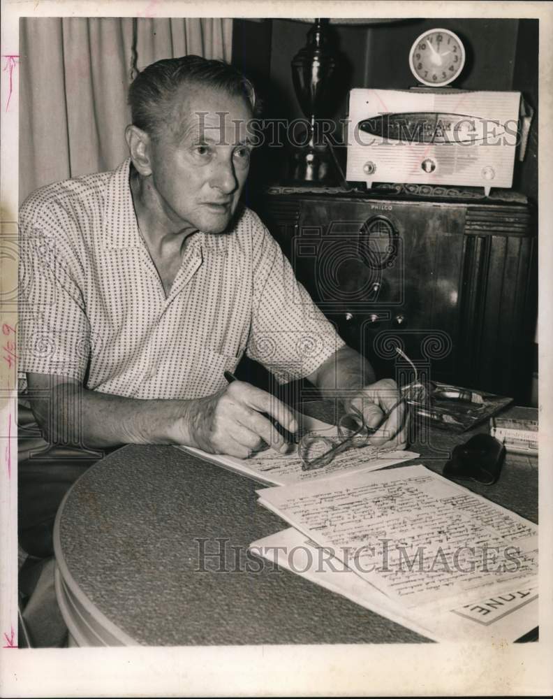 1961 Press Photo Max Thal writes at table in his home - hcb32146- Historic Images