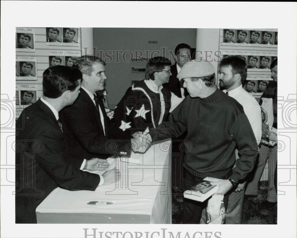 1991 Press Photo Oliver North greets fan Allen Wylie at book-signing in Houston- Historic Images