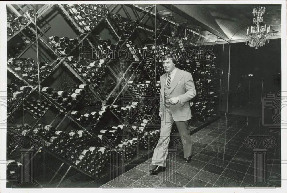 1983 Press Photo Nick Nickolas walks in Houston&#39;s Nick&#39;s Fishmarket wine cellar- Historic Images