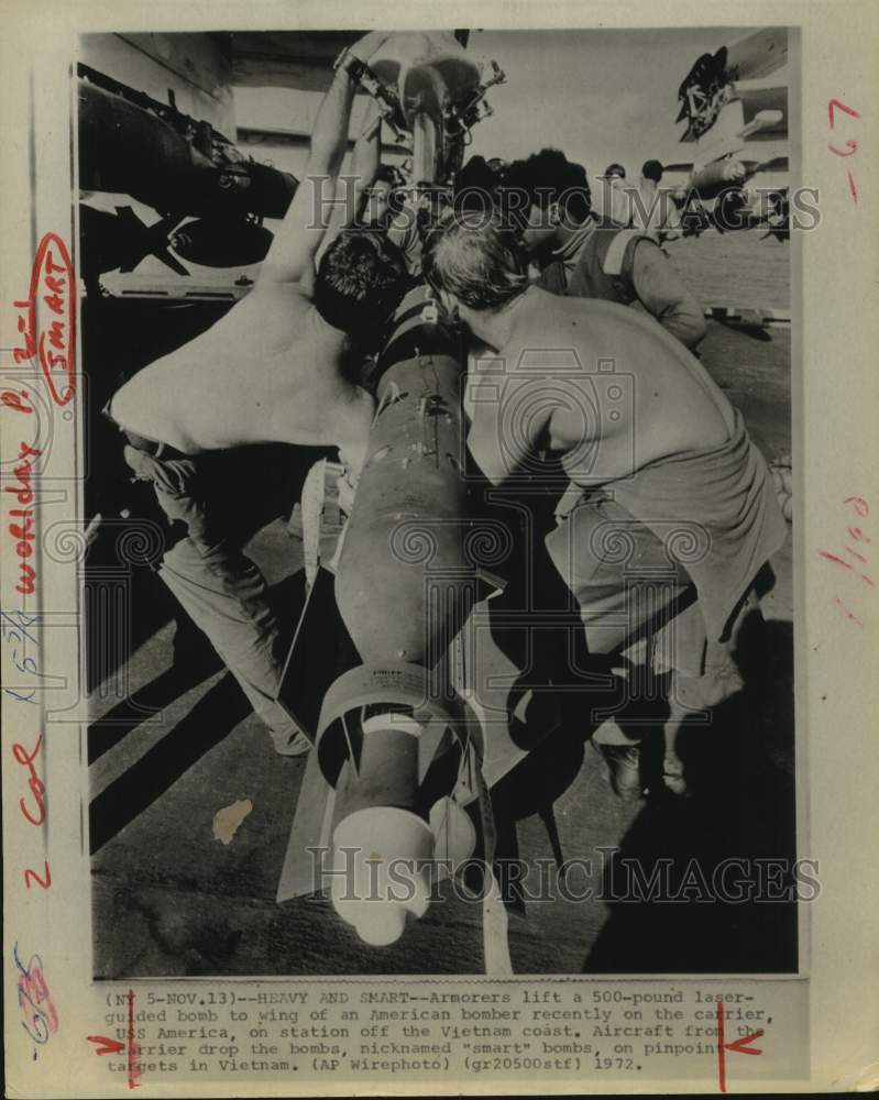 1972 Press Photo "Smart Bombs" loaded onto wing of American bomber - Vietnam
