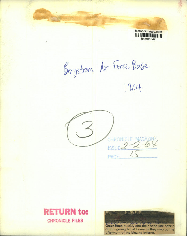 1964 Press Photo Bergstrom Air Force Base firemen spray lingering flame