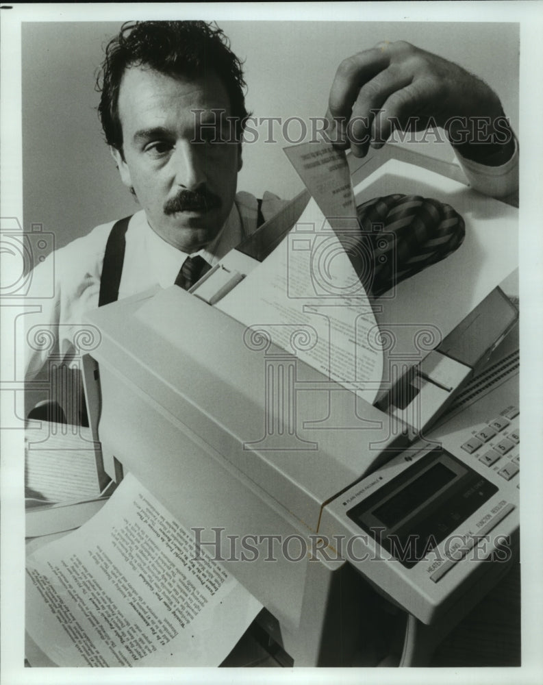 1993 Press Photo Gerald Ganguzza inspects facsimile machine at testing lab- Historic Images