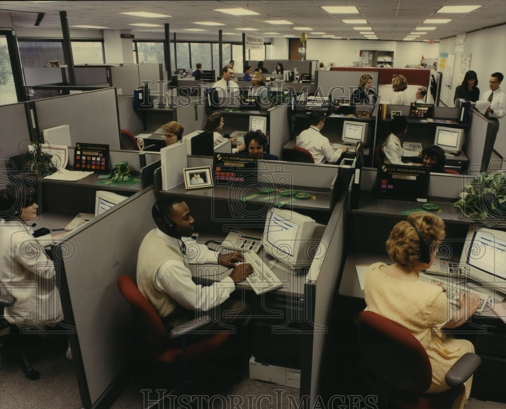 1997 Press Photo Workers shown inside the company of CUC International.- Historic Images