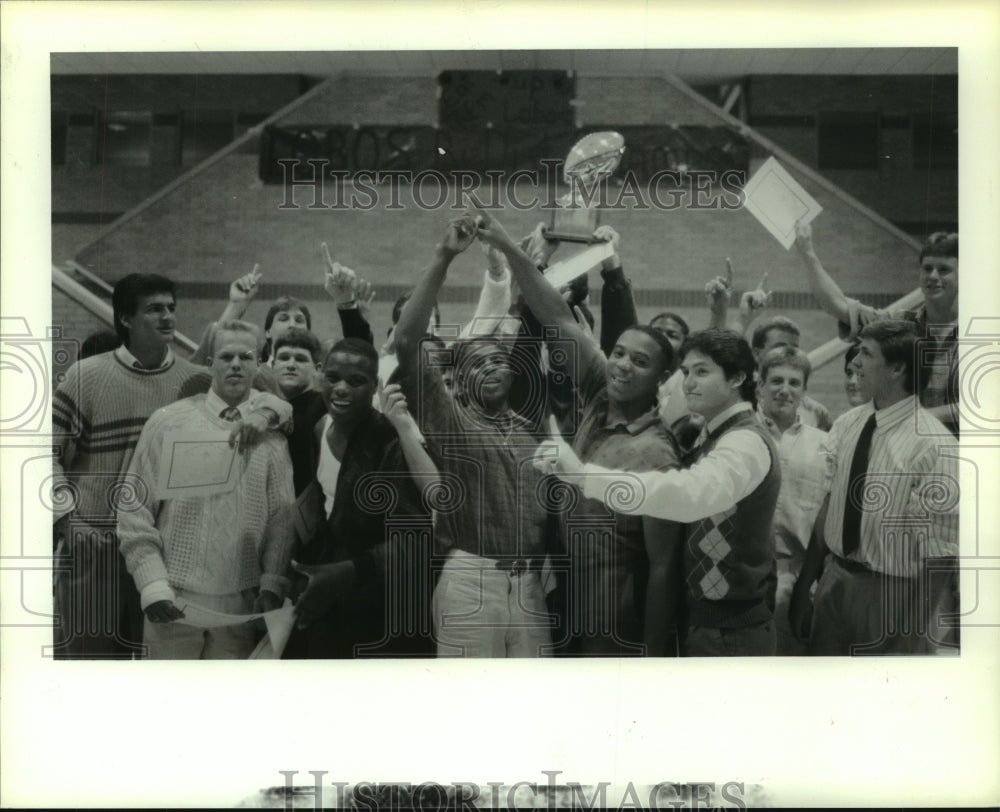 1987 Press Photo High School football team members hoist trophy after banquet.- Historic Images