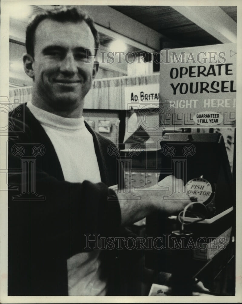 1968 Press Photo Football player Harold Hays checks out fishing equipment.- Historic Images