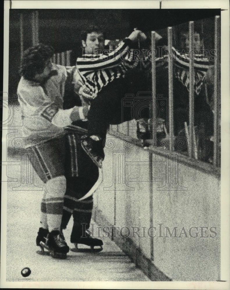 1973 Press Photo Hockey referee climbs wall to get out of way of puck, players- Historic Images