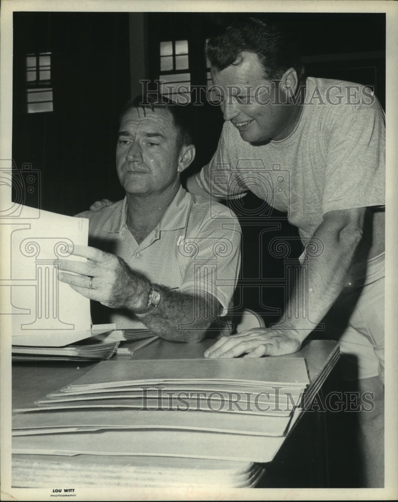 1970 Press Photo Bobby Guinn and Bobby Brown look over paperwork. - hcs06544- Historic Images