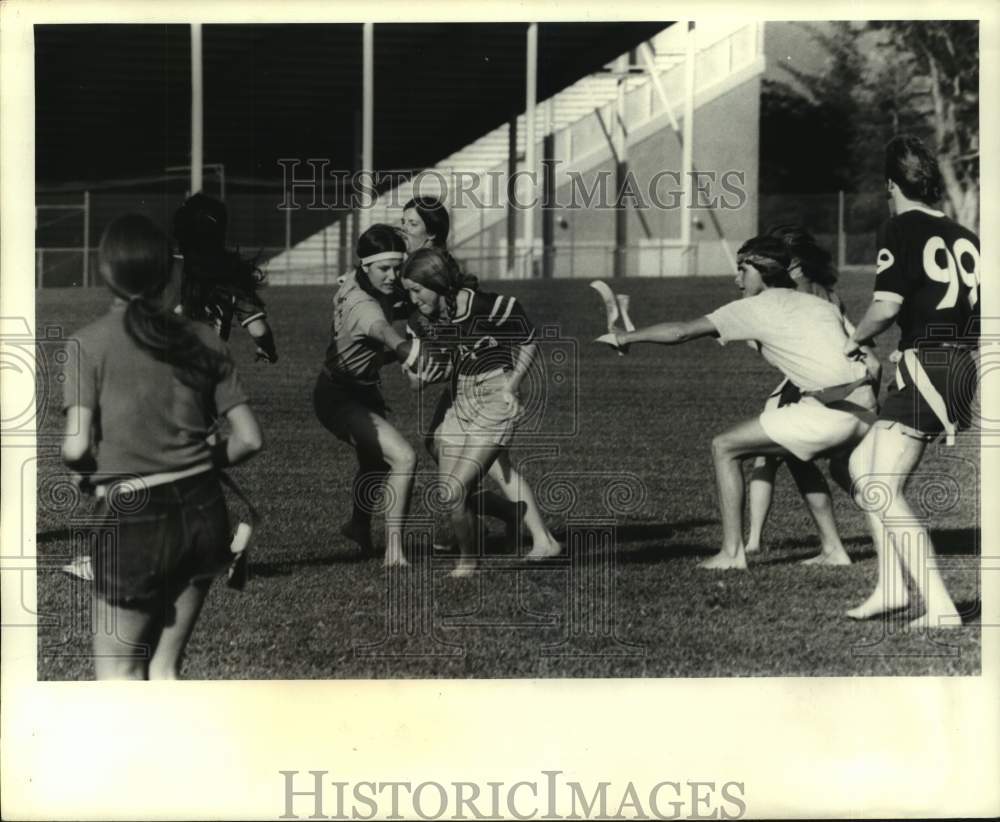 1972 Press Photo Cindy Knight charges on as opponent pulls flag in football game- Historic Images