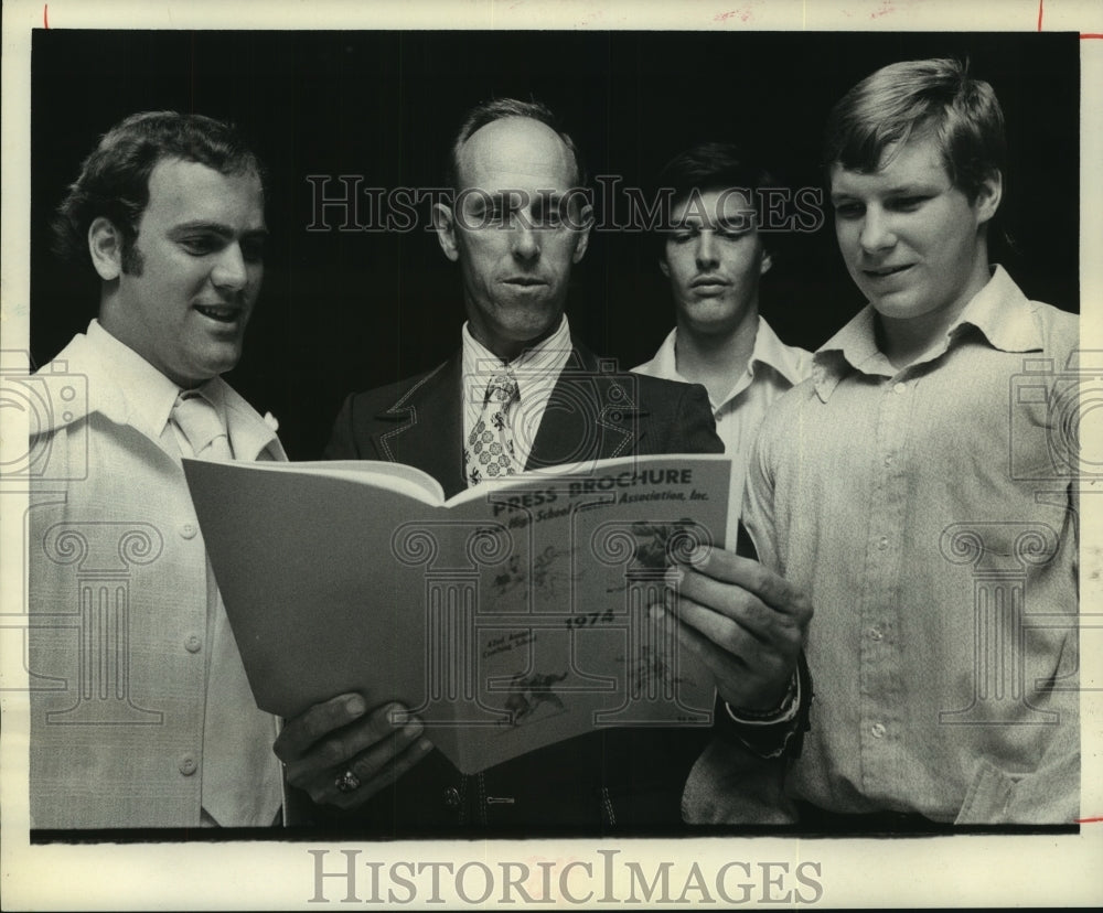 1974 Press Photo South All-Star football Marvin Gustafson looks at program- Historic Images