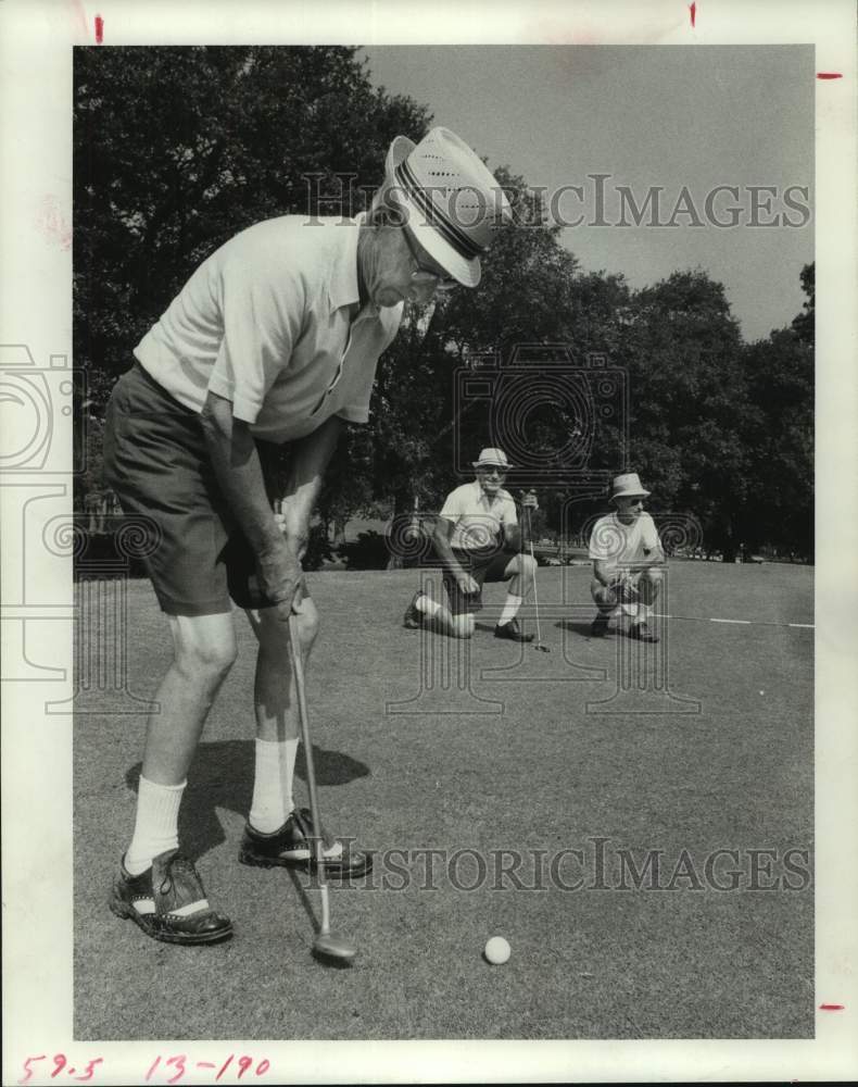 1975 Press Photo Golfer putts in Senior Citizens Golf Tournament. - hcs12354- Historic Images