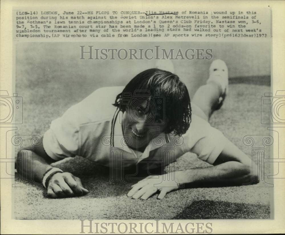 1973 Press Photo Ilie Nastase on stomach during tennis match, London - hcs15729- Historic Images