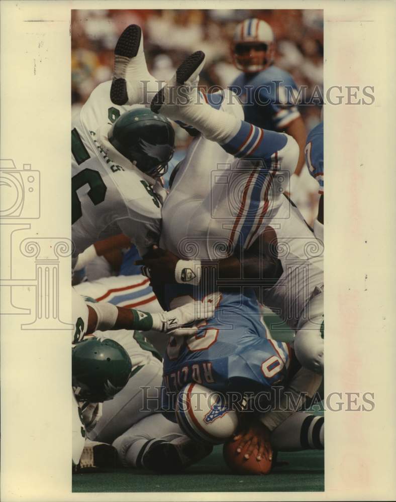 1988 Press Photo Oilers&#39; Mike Rozier is upended on carry against the Eagles.- Historic Images