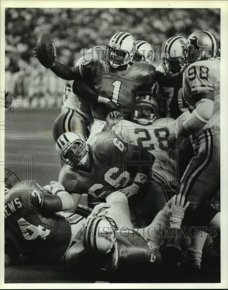 1990 Press Photo Houston Oilers football player Warren Moon holds ...
