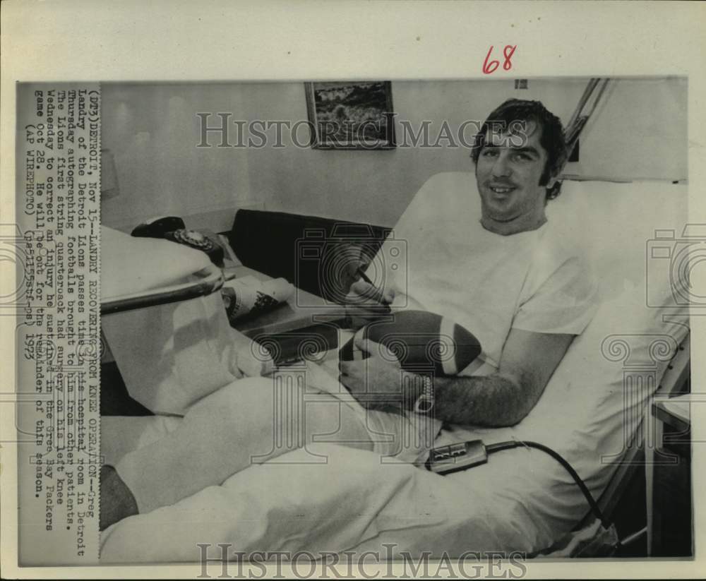 1973 Press Photo Greg Landrey of the Detroit Lions autographs footballs in room- Historic Images