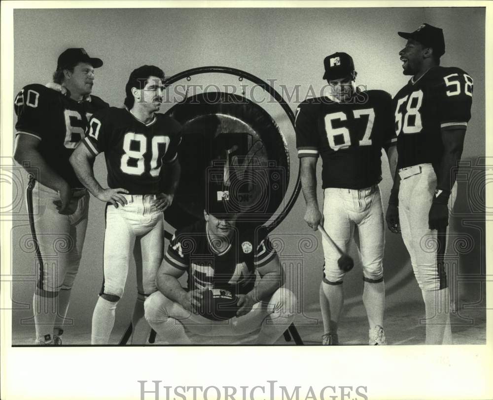 1987 Press Photo Football players pose with a gong - hcs22417- Historic Images