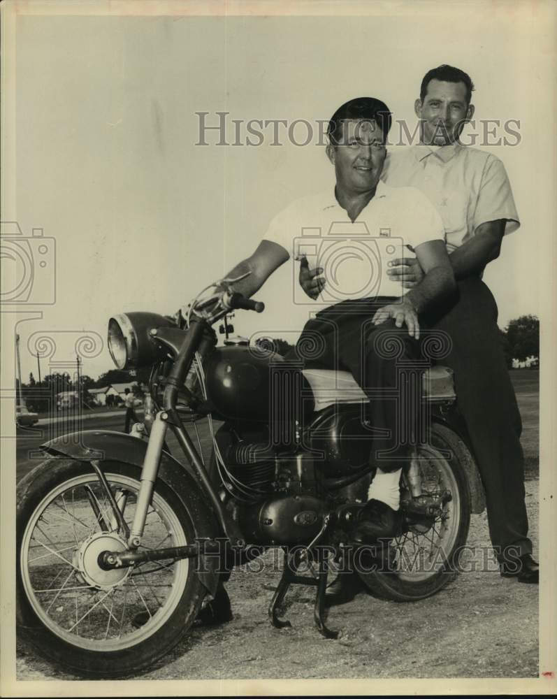 1961 Press Photo Tom Tyson and man astride a motorcycle - hcs26018- Historic Images