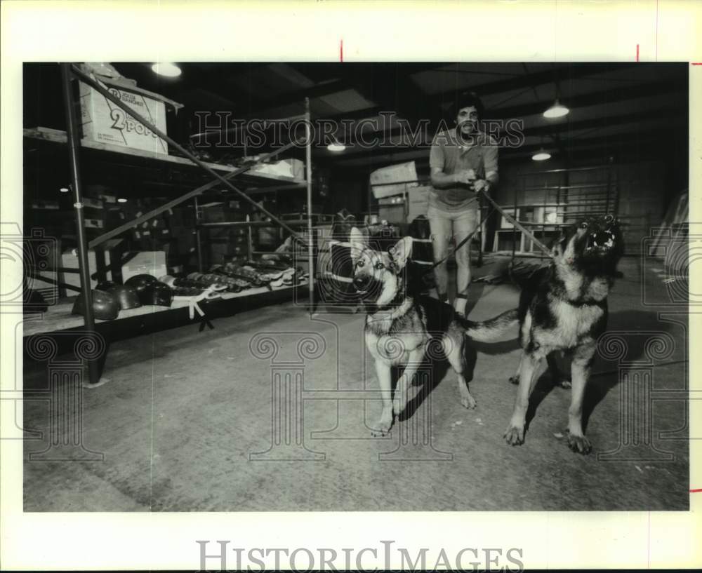 1986 Press Photo Dogs guard items in Olympic Sports Festival warehouse, Houston- Historic Images