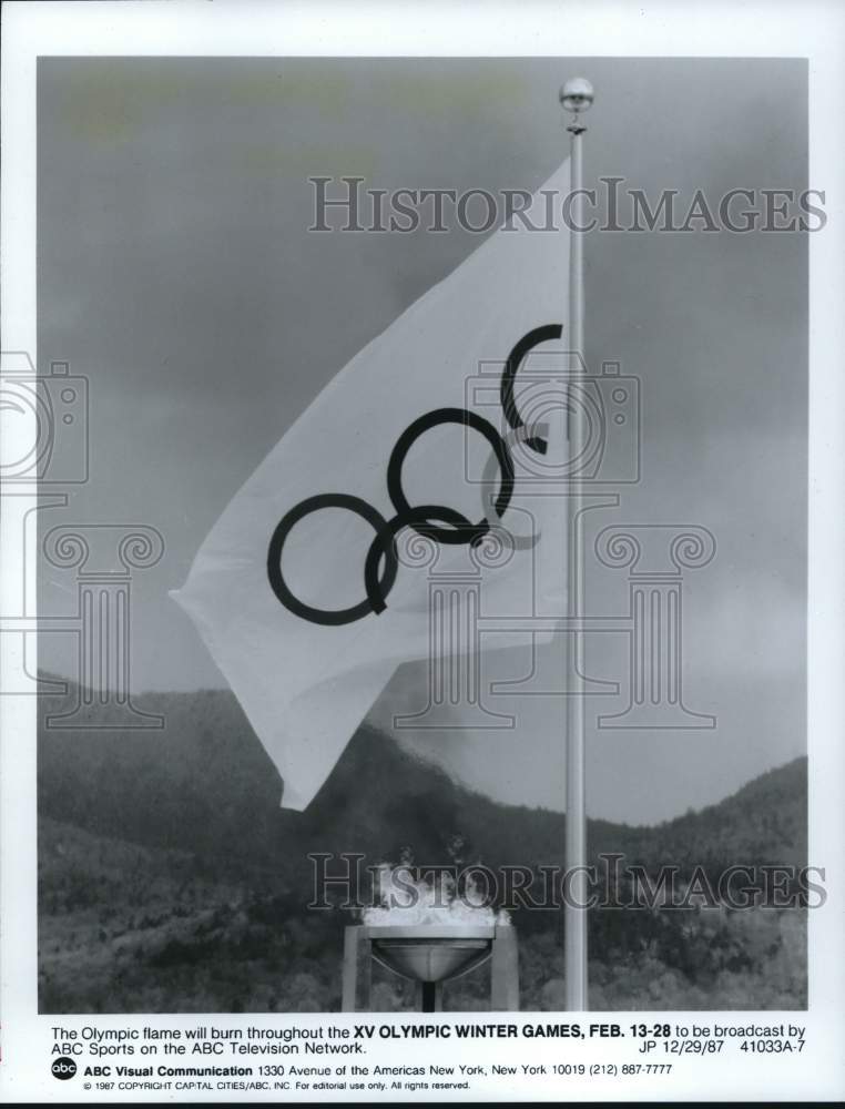 1987 Press Photo Olympic Flame and Flag at the XV Olympic Winter Games- Historic Images