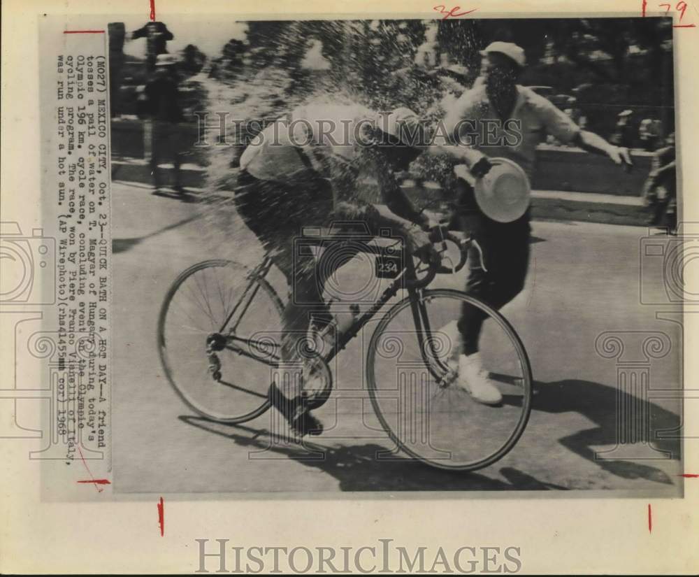 1968 Press Photo Olympic cyclist T. Magyar gets wet during race in Mexico City- Historic Images