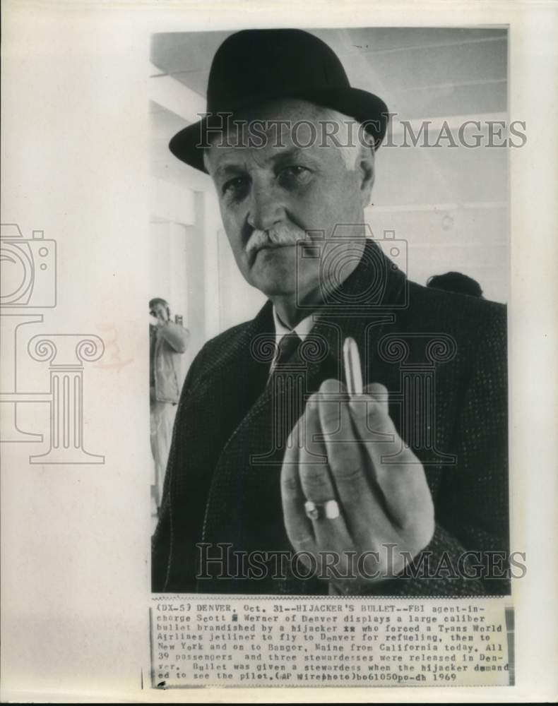 1969 Press Photo FBI agent Scott Werner holds bullet from Trans World hijacker.- Historic Images