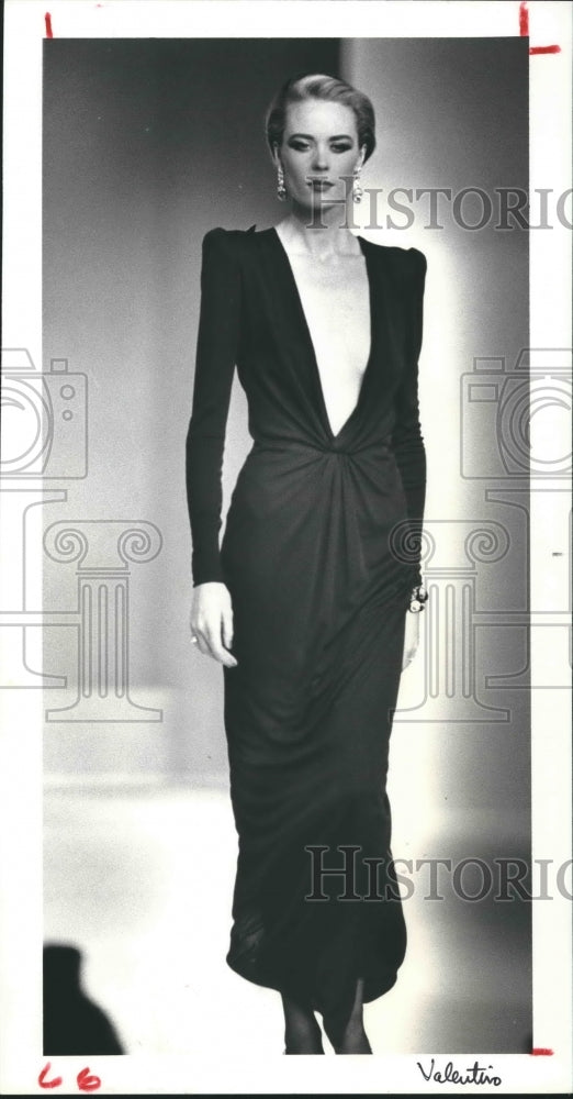 1983 Press Photo Fashion Model Wearing Yves St. Laurent's Black Evening Dress.- Historic Images