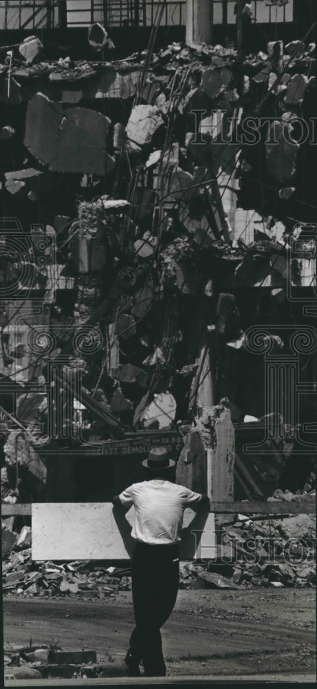 1966 Press Photo man views pile of rubble from fallen walls - hcx04126- Historic Images