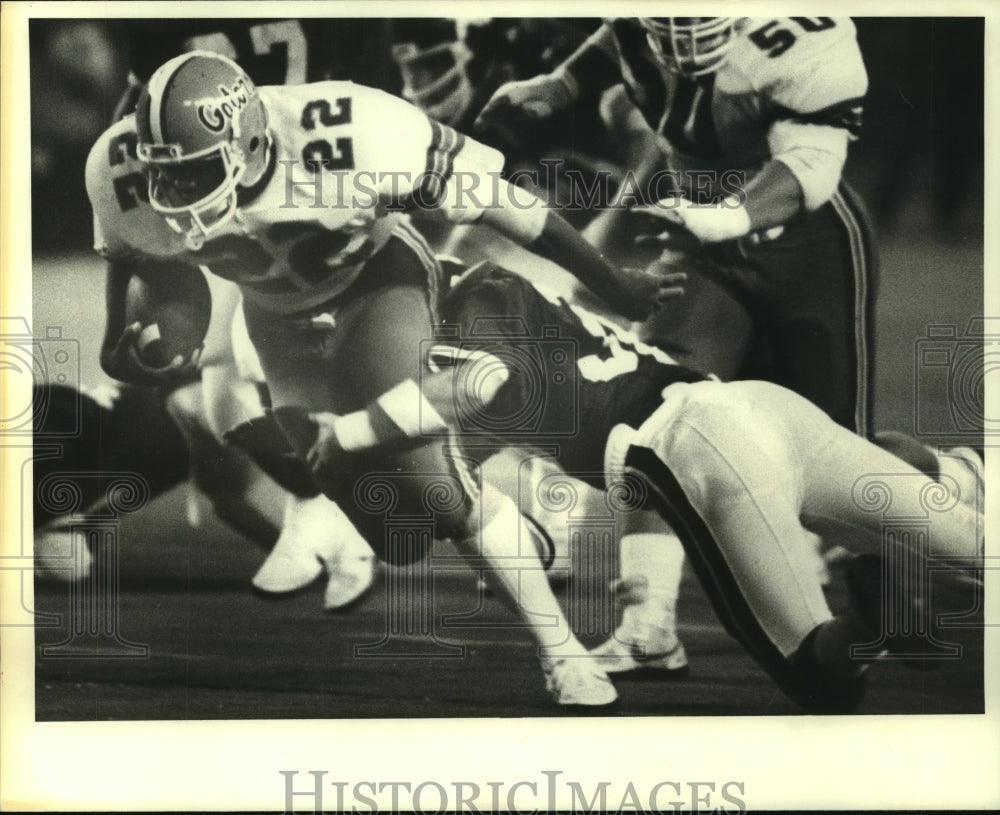 1983 Press Photo John L. Williams Brought Down By Terry Tatum at Bluebonnet Bowl- Historic Images