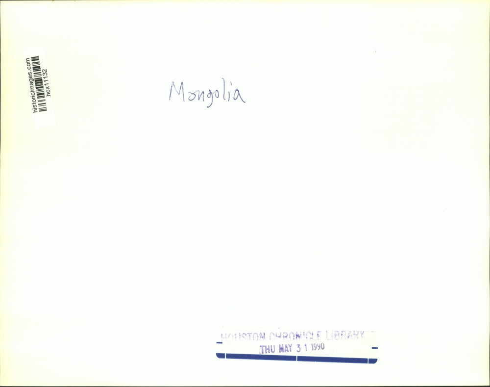 1990 Press Photo Mongolian Woman Spins Prayer Wheel & Horse Riders - hcx11132