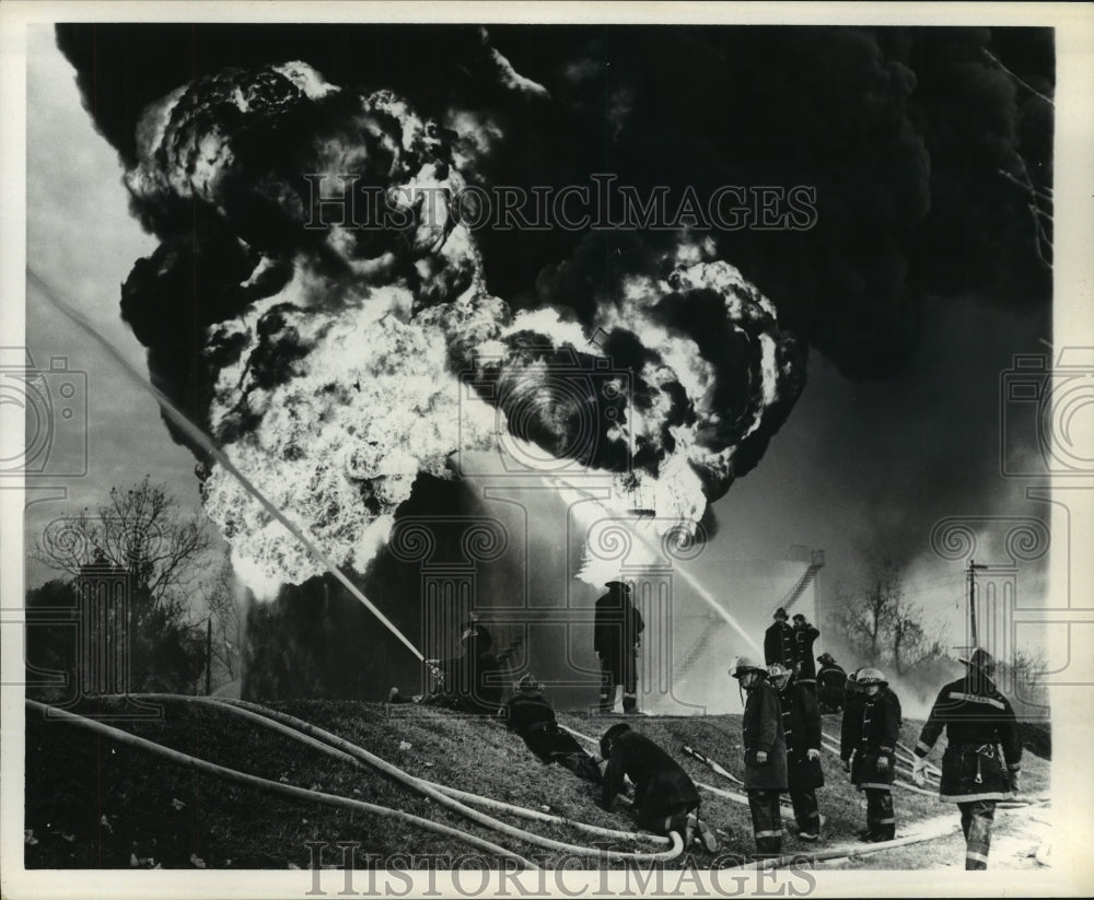 1969 Press Photo Firemen spray water on fire at Mobile Oil Corp. - hcx11367- Historic Images