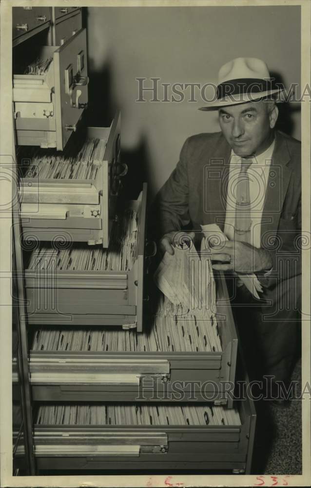 1957 Press Photo Man by file cabinet filled with Houston traffic violations