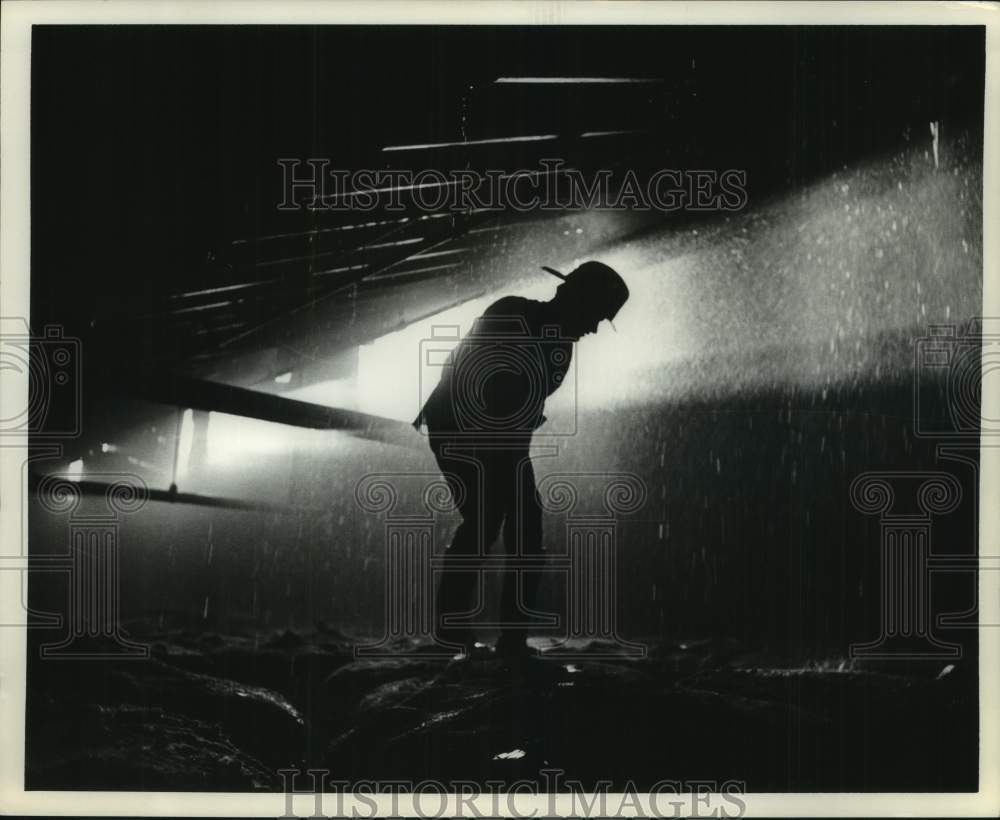 1967 Press Photo Fireman Climbing Across Bales of Cotton, Houston, Texas