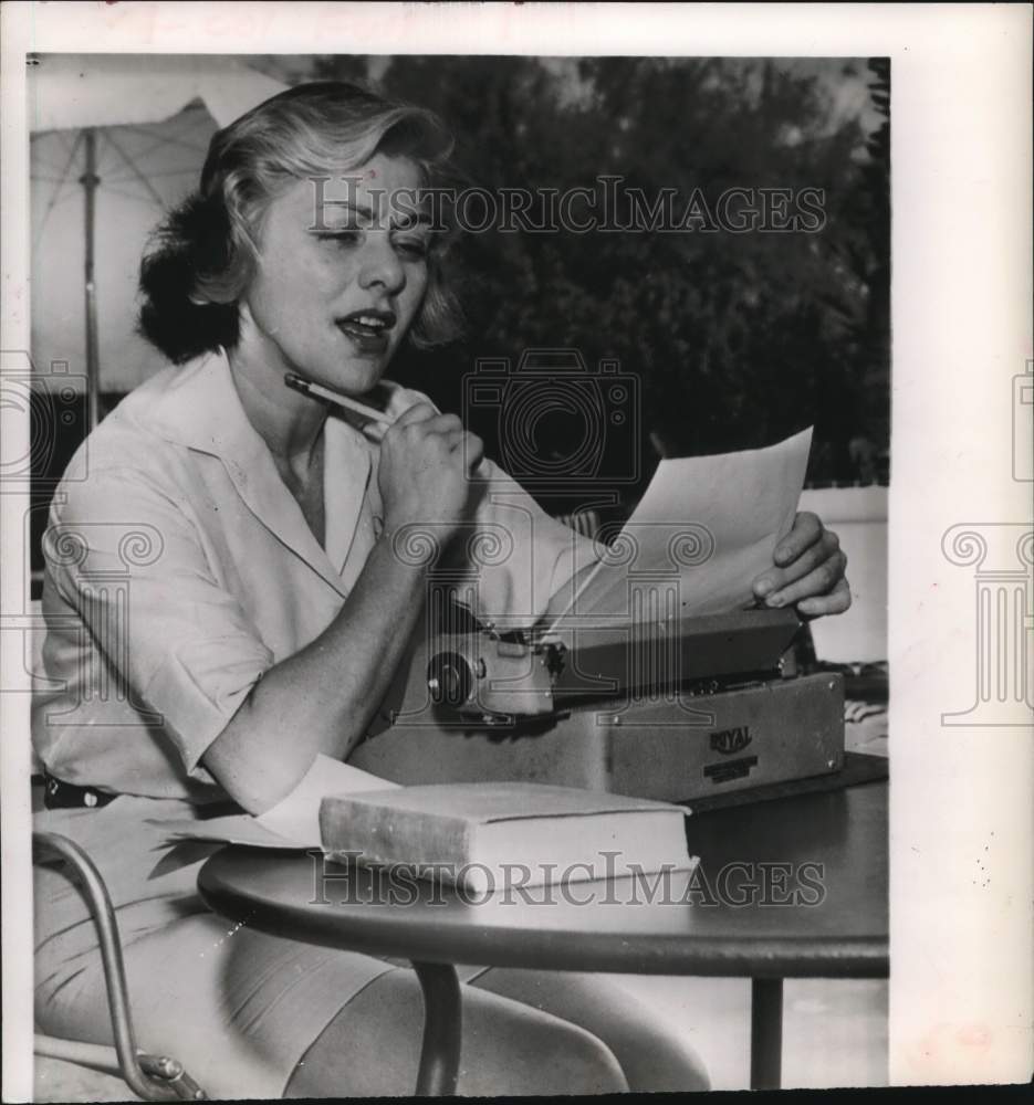 1957 Press Photo Lillian Roth, actress, sits at typewriter. - hcx52132- Historic Images