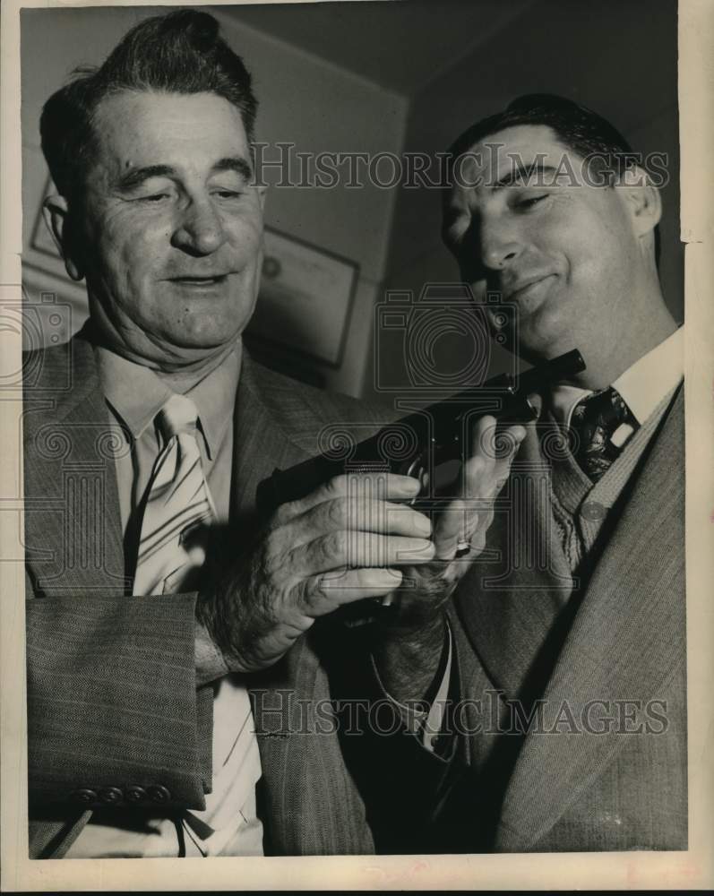 1951 Press Photo Jeff Spencer with another man inspect weapon. - hcx52172- Historic Images