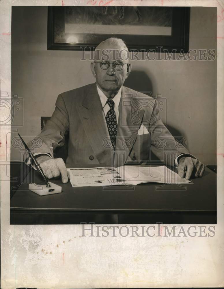 1949 Press Photo John T. Scott, Sr., reads magazine at his office desk.- Historic Images