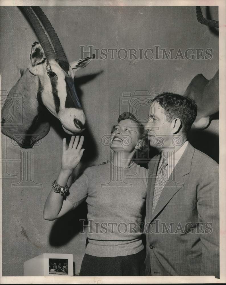 1951 Press Photo Mr. and Mrs. Straus admire their trophies. - hcx52258- Historic Images