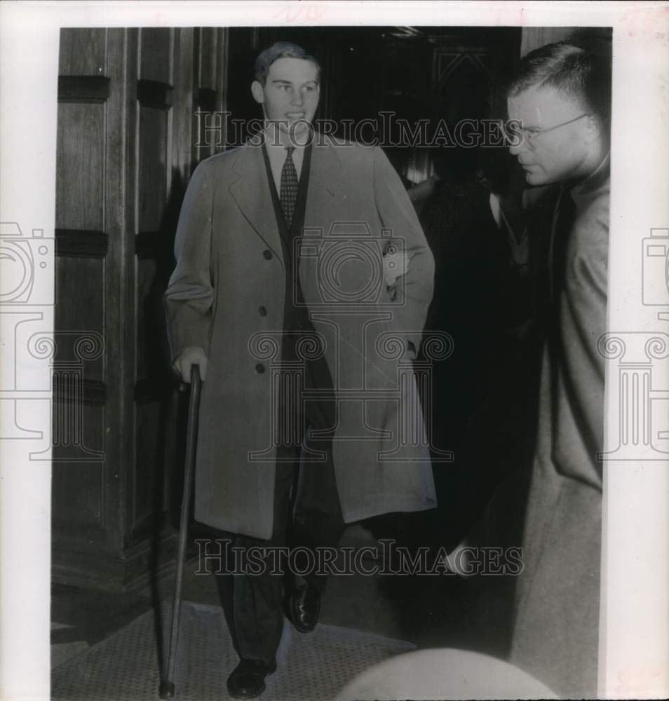 1956 Press Photo John Fell Stevenson walks from building with help of cane.- Historic Images