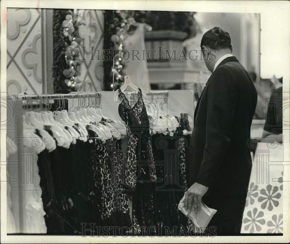 1971 Press Photo Shopping customer looks through women&#39;s fashions. - hpa00271- Historic Images