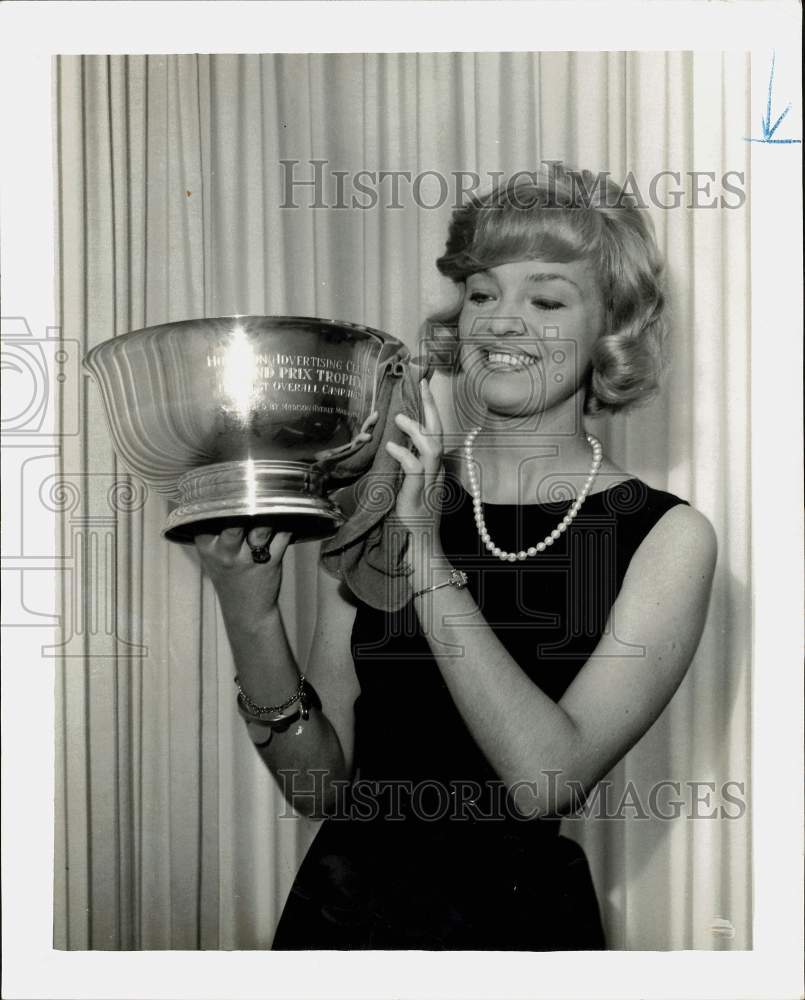 1968 Press Photo Joyce Trautwig polishes Grand Prix II trophy. - hpa25560- Historic Images