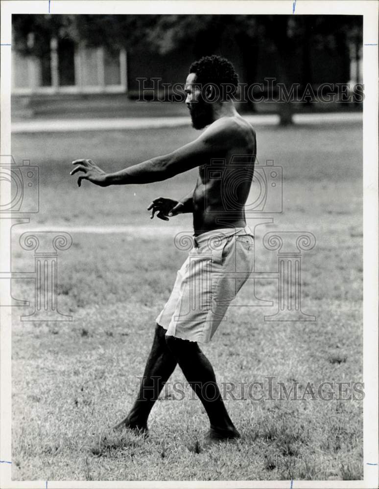 1974 Press Photo Man in a park demonstrating a karate move - hpa27984- Historic Images