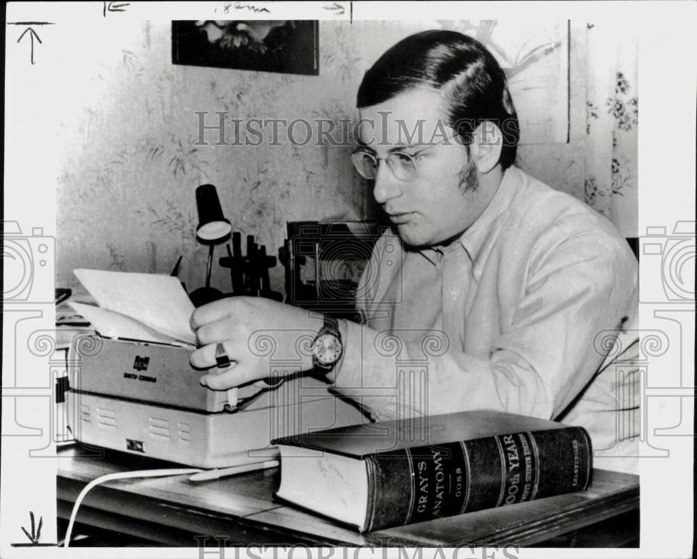 1973 Press Photo Man sits at his typewriter and works on correspondence.- Historic Images